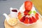 Strawberry kakigori Japanese shaved ice dessert flavor with vanilla ice-cream or bingsu Korea dessert serve on white bowl with