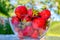 Strawberry. Large freshly picked strawberries in glass container. Rays of sun