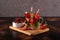 Strawberry lemonade with ice in glass on wooden background