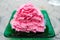 Strawberry milk shaved ice looks like snow In green dish