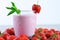 Strawberry milkshake closeup and white background