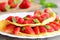 Strawberry omelette. Fried omelette filled with fresh strawberries and garnished with mint on a plate. Fresh strawberries