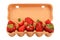 Strawberry in open brown egg carrier over white