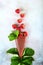 Strawberry paste rolls into a cone. Strawberry berry on a light background with strawberry leaves. Cone of pastes. Copy of the