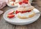 Strawberry pastry with whipped cream and marinated strawberries filling. Traditional british shortcake