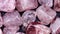 Strawberry quartz heap jewel stones texture on black background. Moving right seamless loop backdrop