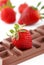 Strawberry resting on chocolate