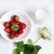 Strawberry, rose and glass of milk