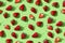 Strawberry seamless pattern, red ripe strawberries on green colored background, top view, flat lay, summer pattern. Trendy