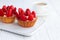 Strawberry shortcake pies strawberries tartlets with custard on white wooden background