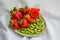 Strawberry, sliced kiwi and rose on the plate