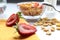 Strawberry slices on the background of corn flakes in a glass container, close - up-the concept of cooking fast and nutritious