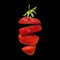 Strawberry slices isolated on black background. Surreal design. Pieces of fruit floating in the air