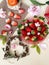 Strawberry  and slices  on white background ,table setting ,flowers in red cup ,and ,branch in heart shape still life