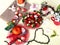 Strawberry  and slices  on white background ,table setting ,flowers in red cup ,and ,branch in heart shape still life