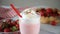 Strawberry smoothie milk shake cocktail with whipped cream. Sprinkle candy decoration