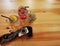 Strawberry soda, peach soda , dried flowers and camera on a wooden table.