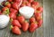 Strawberry sugar and yogurt on a wooden table.