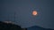 Strawberry Super Moon rise over water tank