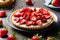 Strawberry Tart on a platter that sits on a table. Generative-AI
