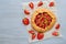 Strawberry tart with rhubarb on the gray kitchen table with copy space. Vegetarian galette decorated with fresh strawberries