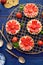 Strawberry tarts, small shortbread tarts with the addition of cream cheese, fresh strawberries and mint on cooling tray