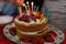 Strawberry vanilla biscuit birthday cake with colorful candles
