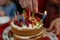 Strawberry vanilla biscuit birthday cake with colorful candles