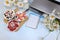 Strawberry yogurt, milk and ripe currant berries and strawberries next to a closed computer on a light background