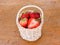 Strawberrys in the basket on wood background