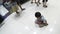 Stray baby boy crawling on mall floor amidst shoppers who couldn`t care less