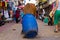 Stray brown cow looking for food in crowded street in india