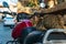 Stray cat naps on the saddle of a parked motorcycle