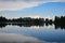 Strbske pleso, lake and small town, in the evening. Buildings and trees reflecting in the lake. High Tatras, Slovakia