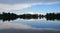 Strbske pleso, lake and small town, in the evening. Buildings and trees reflecting in the lake. High Tatras, Slovakia