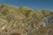 Streaked green and rainbow mountains in Maragua Crater. Bolivia with farm houses