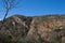 STREAKS OF ROCK RUNNING THROUGH THE SIDE OF A HILL