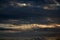 STREAKS OF WHITE CLOUD BELOW HEAVY CLOUDED SKY