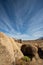 Streaky clouds above rock formation in Alabama Hills of Sierra Nevada mountain in California