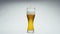 Stream beer pouring glass in super slow motion close up. Wheat alcohol liquid.