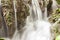 Stream blurred water in small waterfall