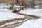 Stream and bridge on a lovely snow covered park in Salt Lake City in winter