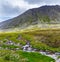 Stream cascades flowing over the rocks in the mountains