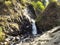 Stream with clear transparent water in the mountains. Water source. Mineral water