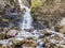 Stream with clear transparent water in the mountains. Water source. Mineral water