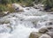 Stream with clear transparent water in the mountains. Water source. Mineral water