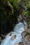 Stream in deep rocky ravine.