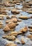 Stream flowing around sandstone boulders