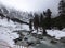 Stream flowing through a frozen valley