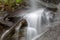 Stream flowing in motion over rocks